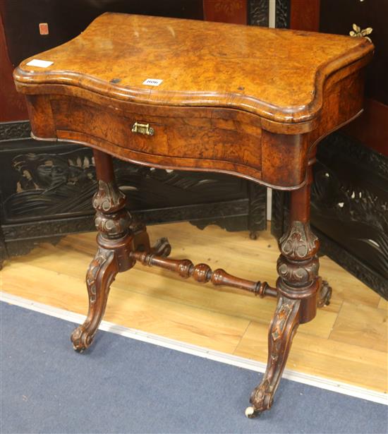 A Victorian walnut games/sewing table, W.66cm